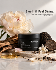 A black jar of TRUFFluv Truffle Mask styled on a marble slab with a large cream peony flower, truffle, wood bark, and scattered truffle pieces against a light neutral background. Text at the top reads 'Smell & Feel Divine.