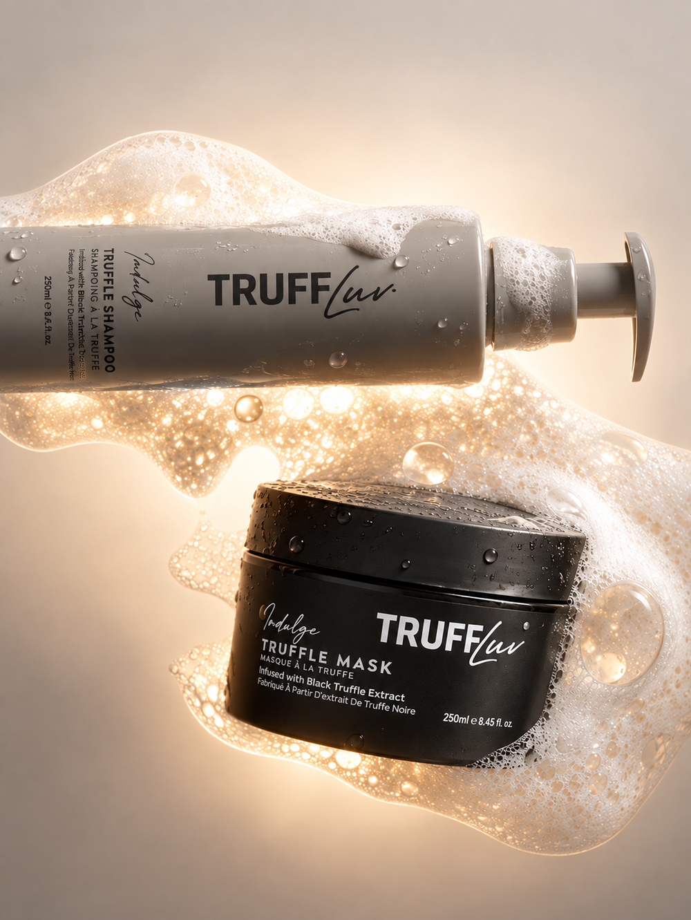 Truffluv Truffle Shampoo and Truffle Mask set, featuring a grey pump bottle of shampoo and a black jar of mask, both labeled with Truffluv branding, floating amidst golden light and white foam bubbles.